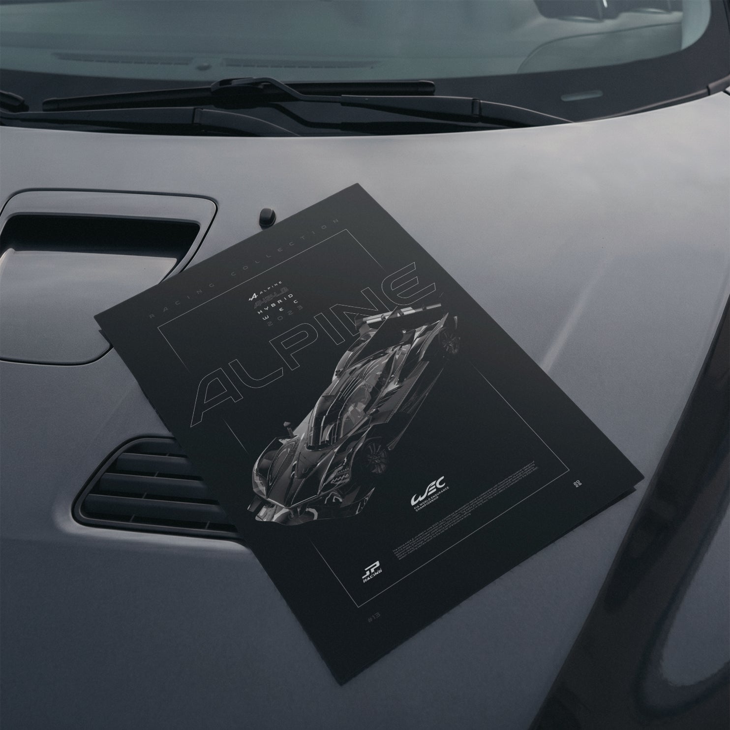 Alpine A424 2023 poster resting on a car hood