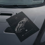 Aston Martin Vantage GT3 2018 poster resting on a car hood