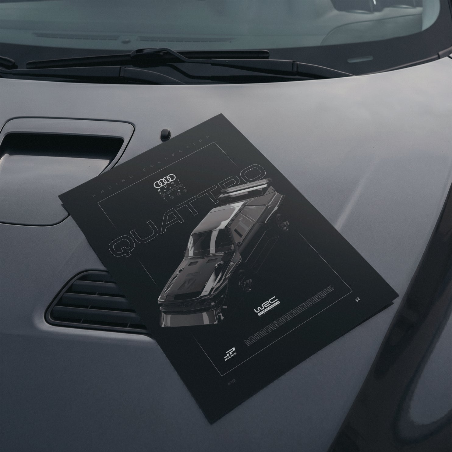 Audi Sport quattro S1 E2 1985 poster resting on a car hood