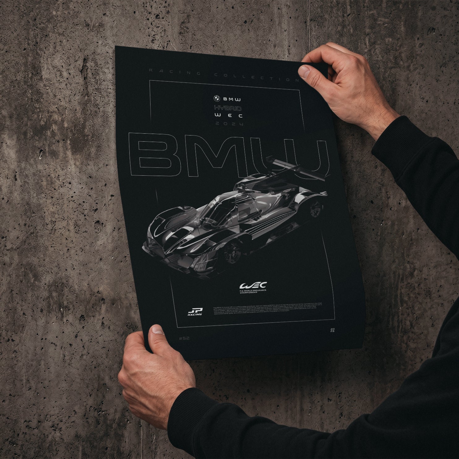 BMW M Hybrid V8 WEC 2024 poster print held in hands against a concrete wall