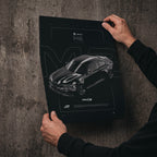BMW M2 FD 2020 poster print held in hands against a concrete wall