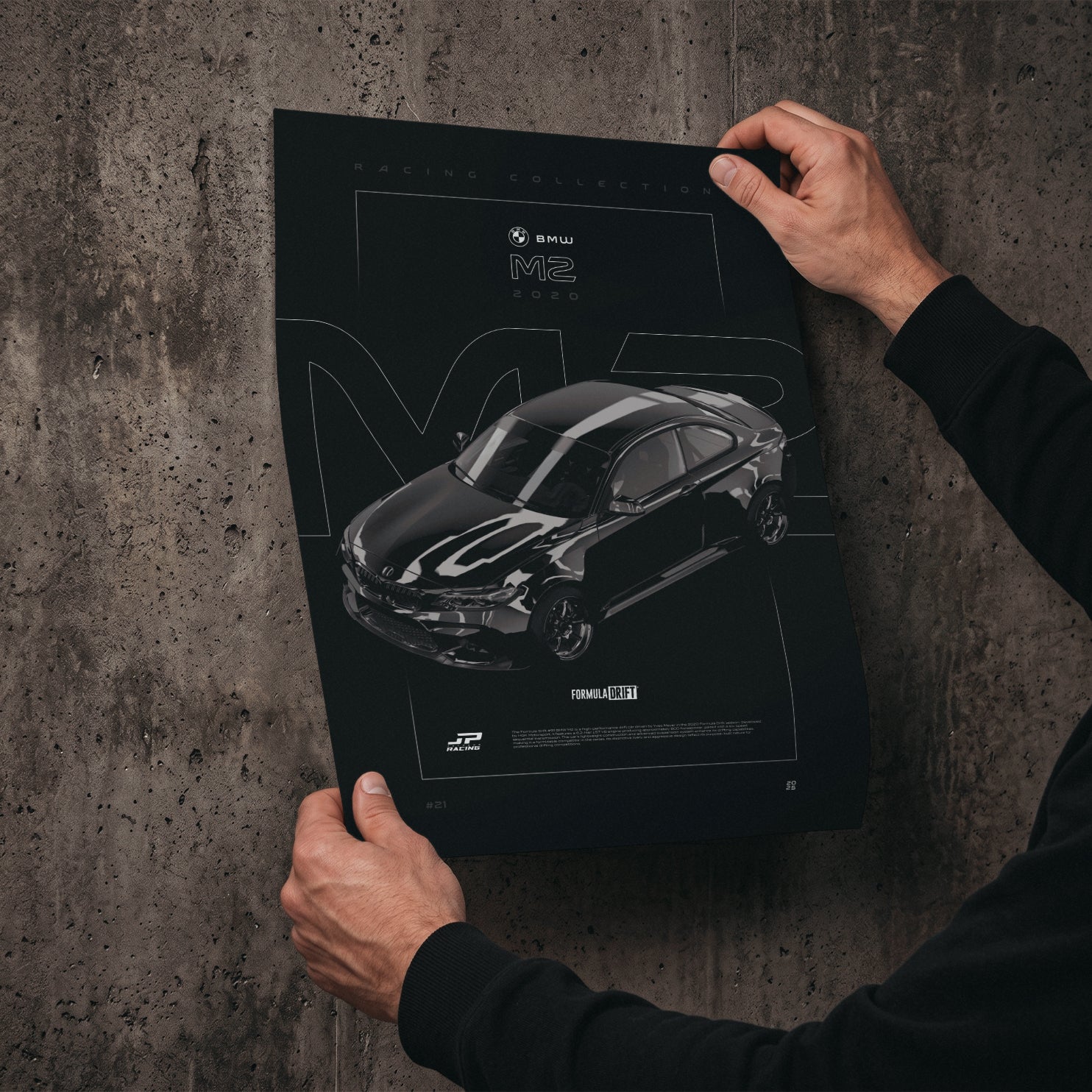BMW M2 FD 2020 poster print held in hands against a concrete wall