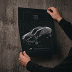 BMW M3 Competition G80 2023 poster print held in hands against a concrete wall