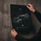 Chevrolet Corvette C6R GT1 2006 poster print held in hands against a concrete wall
