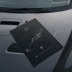 F1 Ferrari SF-24 2024 poster resting on a car hood