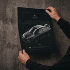 Mitsubishi Lancer GSR Evolution IV 1996 poster print held in hands against a concrete wall