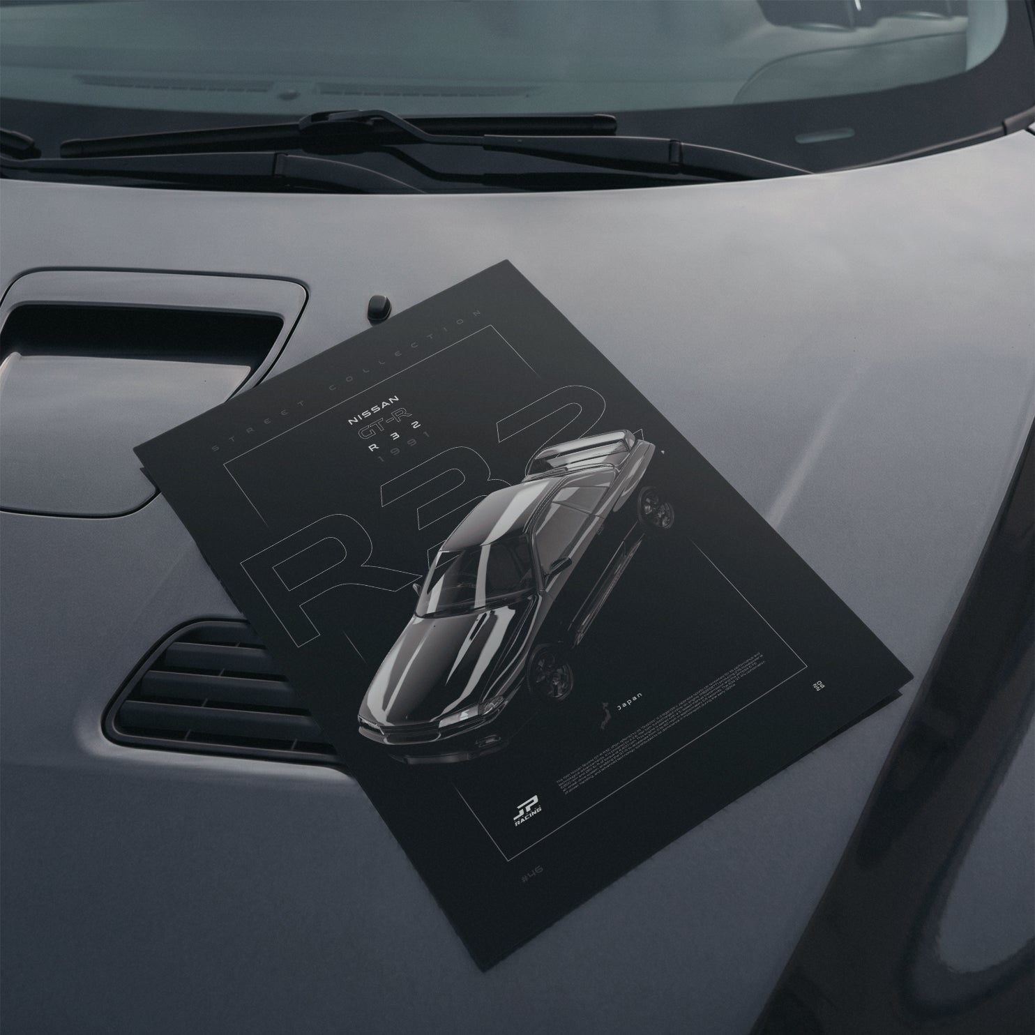 Nissan Skyline GT-R R32 1991 poster resting on a car hood
