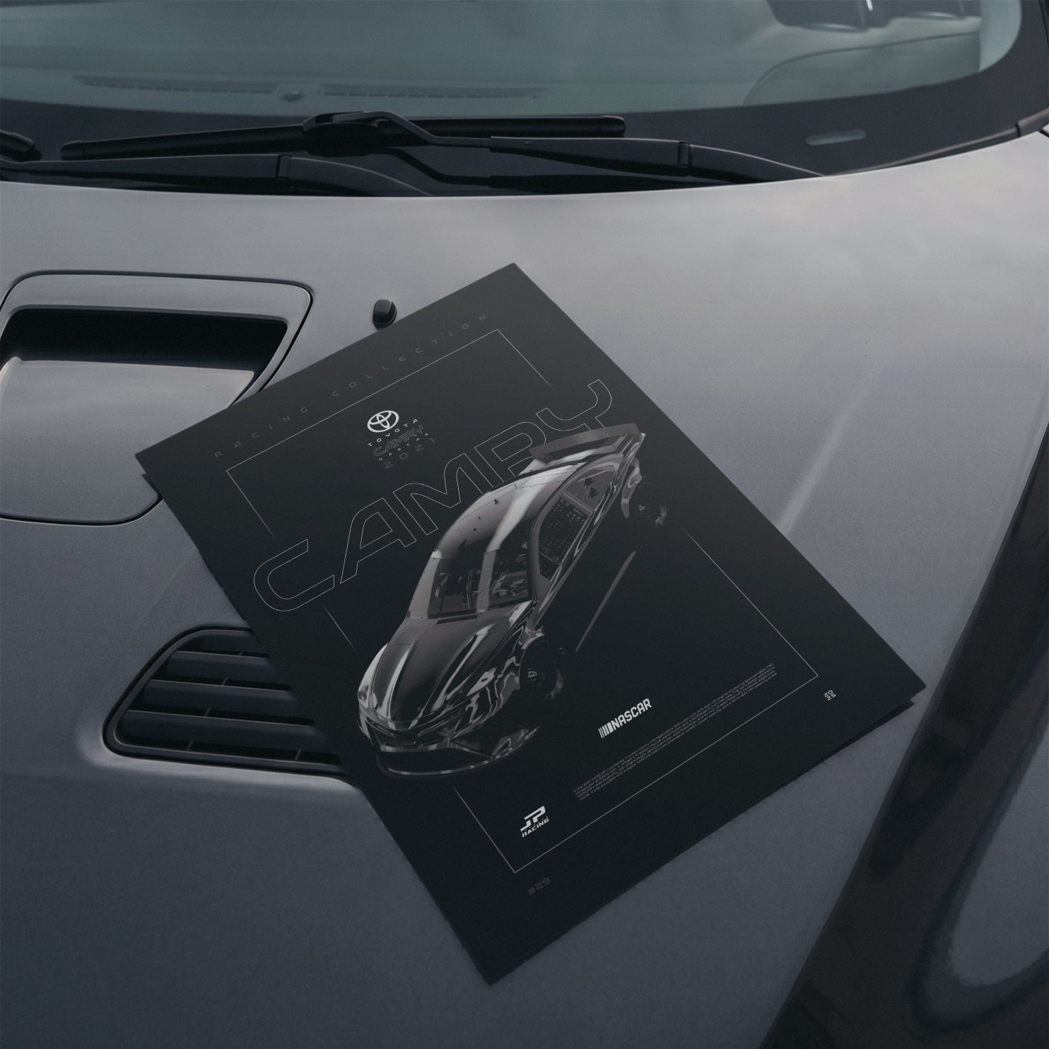 Toyota Camry Nascar 2021 poster resting on a car hood